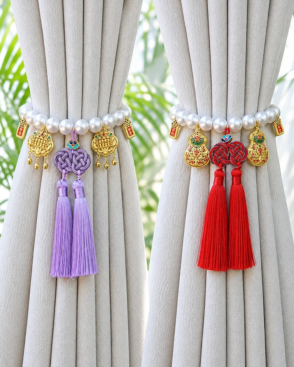 Lavender and red decorative knot tassels with pearl-look beads and gold-tone charms on two softly gathered grey curtains.