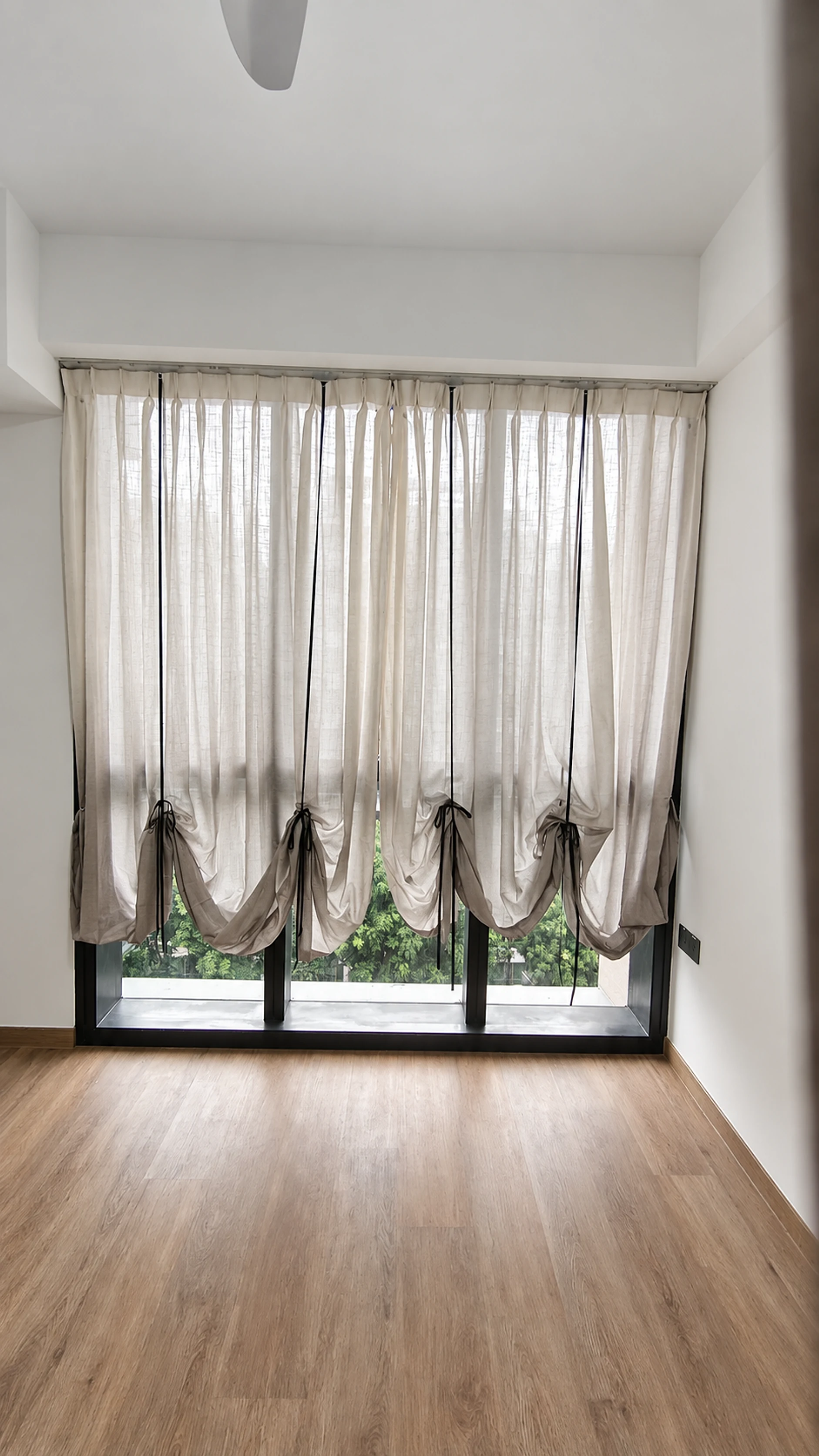 Ribbon bow & gathered sheer festoon — close-up of the supplied curtain photograph.