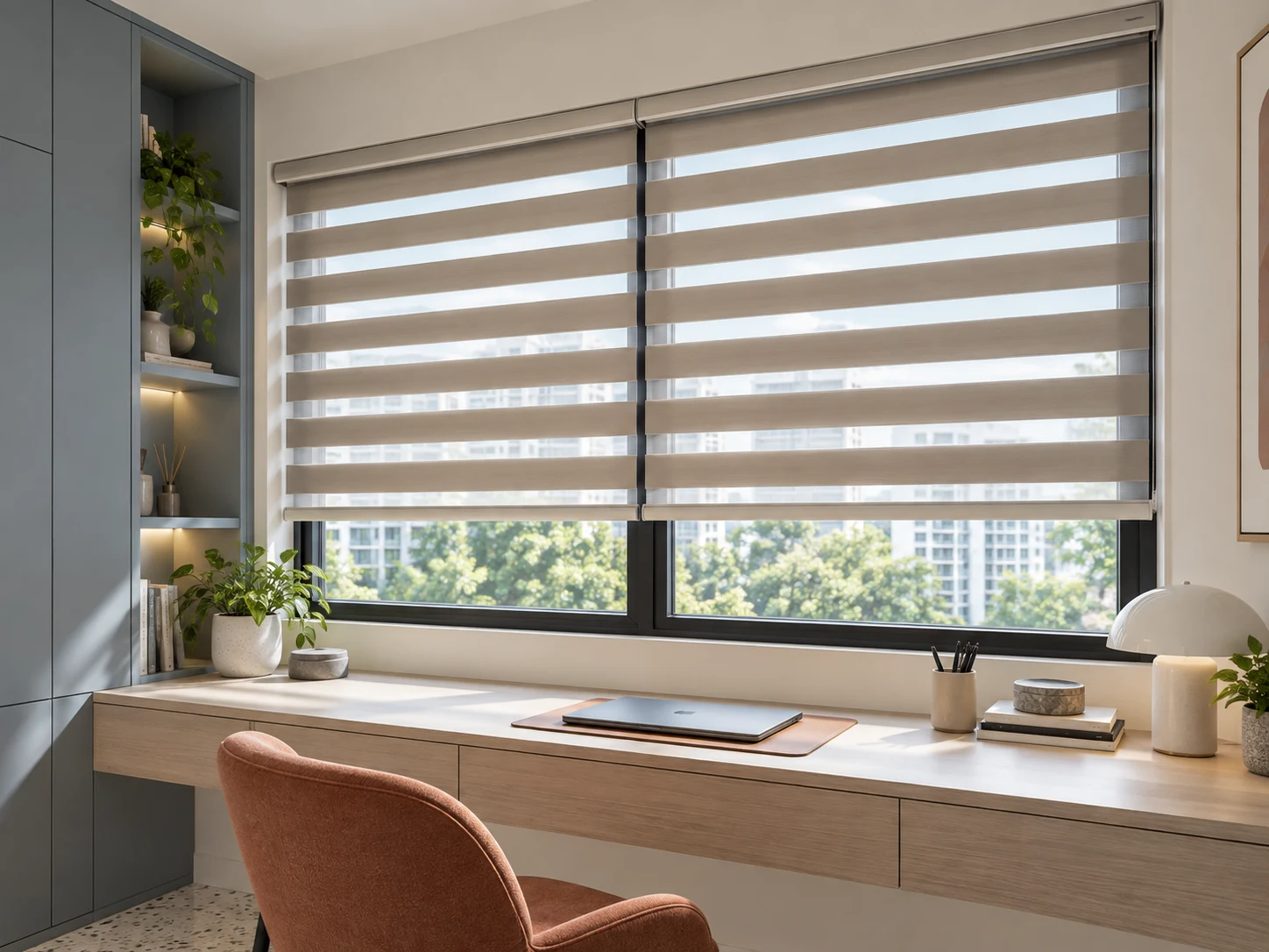 Warm neutral zebra blinds show alternating opaque and transparent horizontal bands above a contemporary study desk.