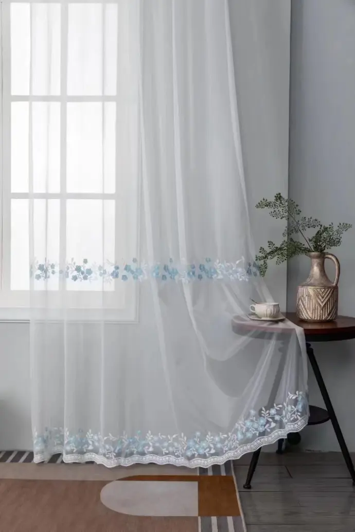 Sheer white curtain in a bright, minimalist room with plants – ideal for boho-chic or Scandinavian interior design inspiration