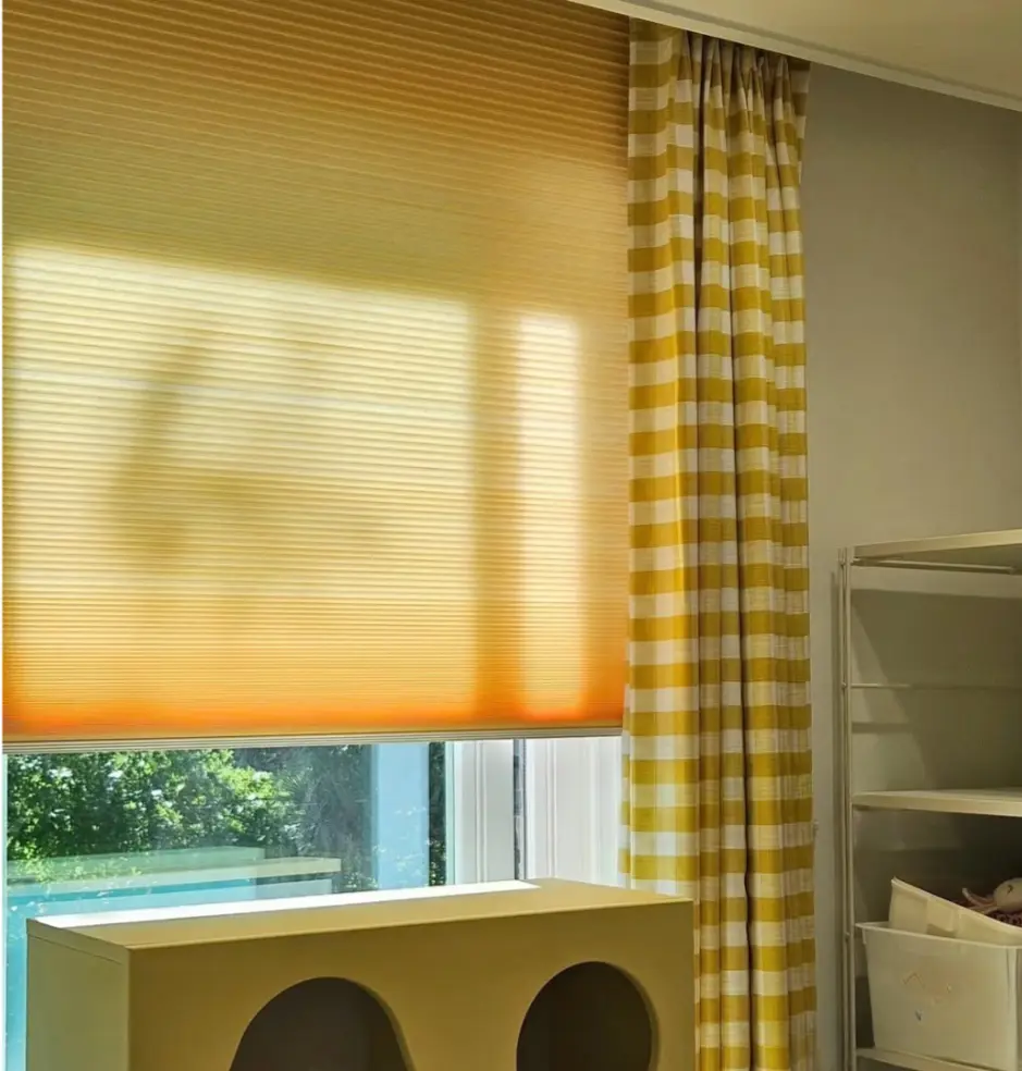 (yellow sheer curtains): Warm yellow sheer window curtains, brightening a sunlit room with soft light