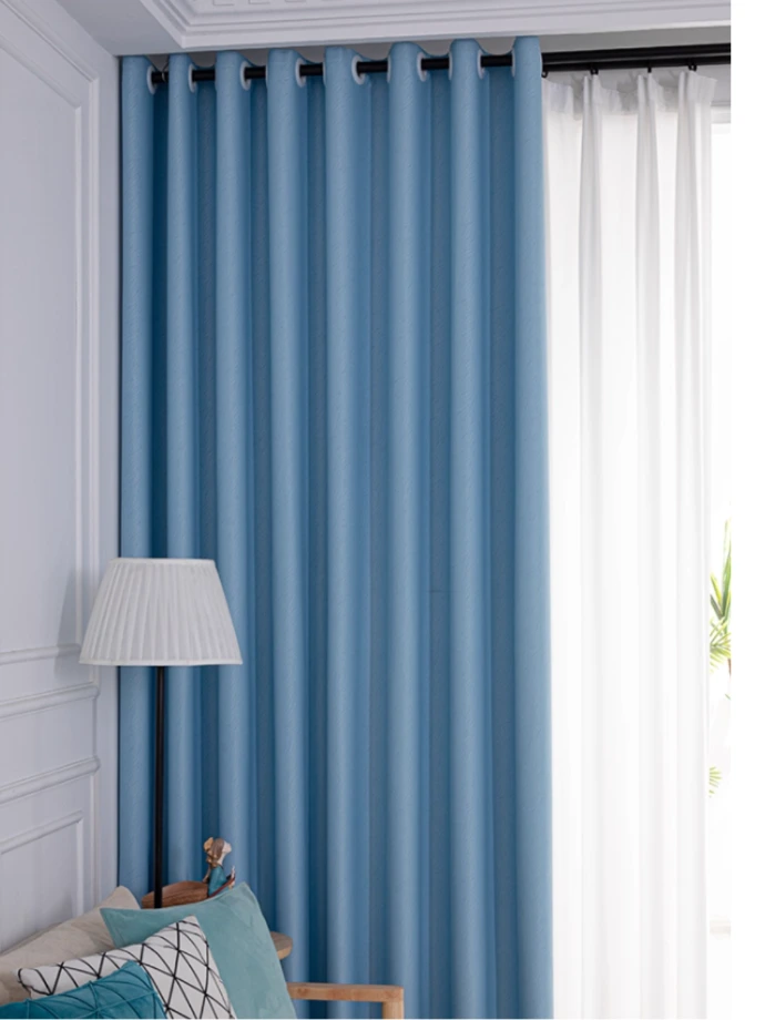 Vibrant blue vertical striped curtains on a window next to a white door with Eyelet ring with bold, colorful home window treatment.